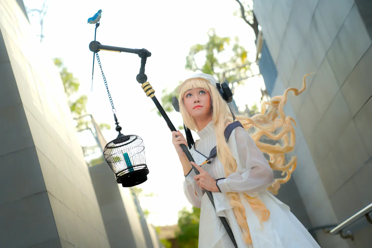 SaltyAom's Nightingale cosplay holding a magical wand while looking up to the sky